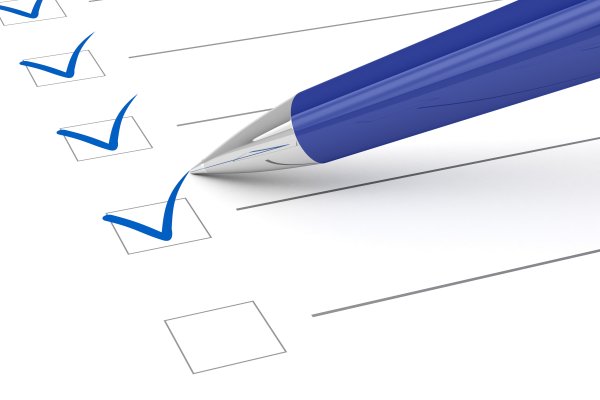 features background check services instant checkmate checking boxes with blue pen on white piece of paper